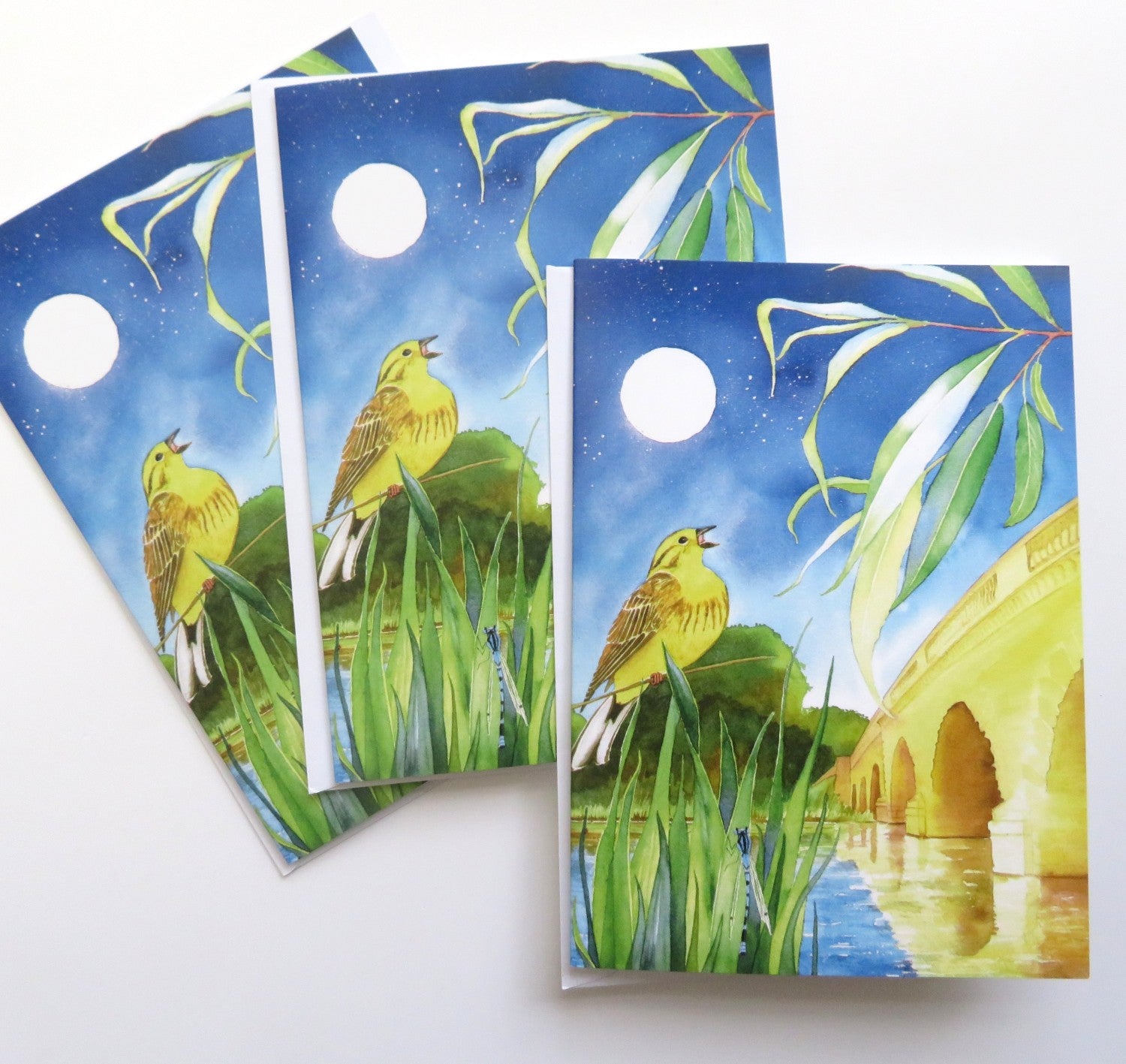 Card of a singing bird and a bridge over a river