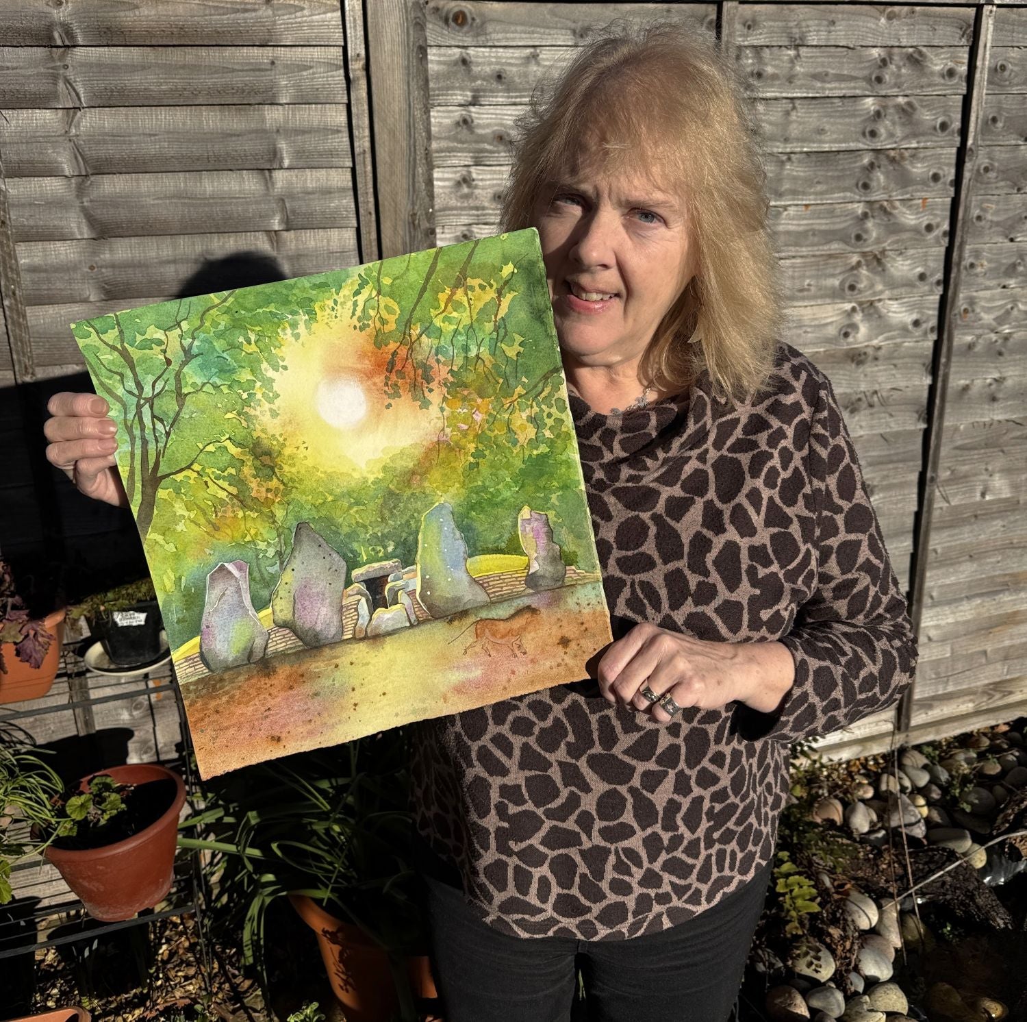 Artist Jane Tomlinson with her painting 'Wayland's Smithy Magic' of an ancient Oxfordshire long barrow